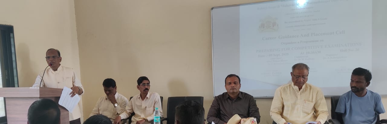 A light brown puppy standing on a white and tan woven pet bed.