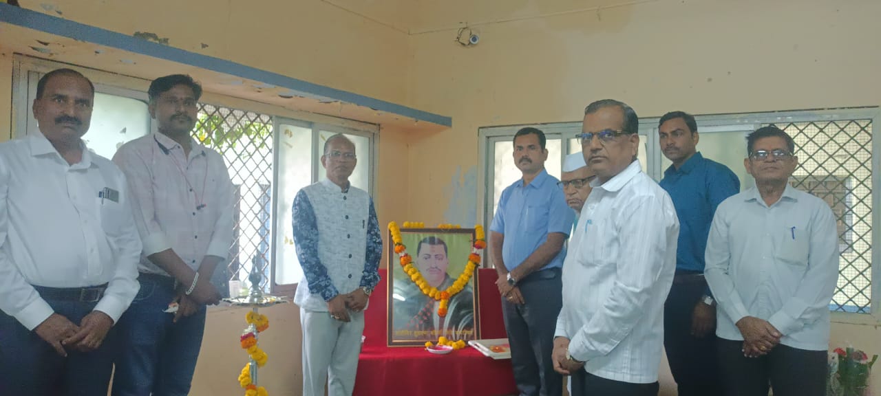 A light brown puppy standing on a white and tan woven pet bed.