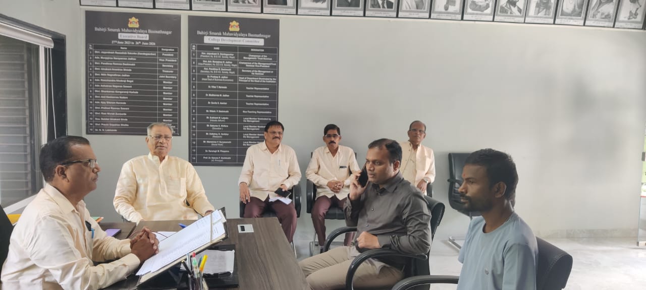 A light brown puppy standing on a white and tan woven pet bed.
